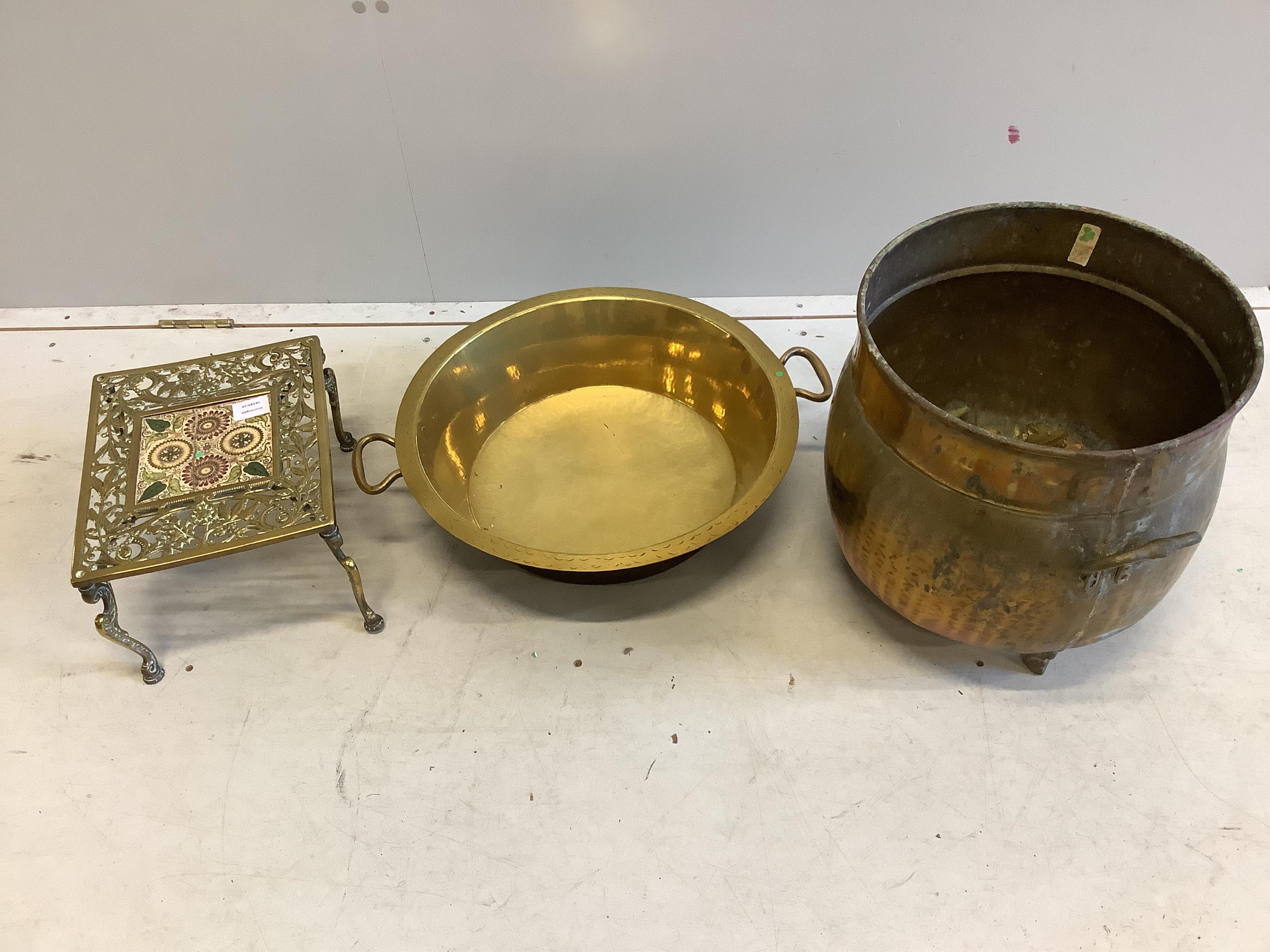 A Victorian brass tile inset trivet, width 26cm, depth 32cm together with a brass dairy pan and a copper log bin. Condition - fair